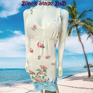 White knit 3/4” long dress with pink blue and green flower designs & sequins.